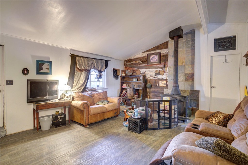 700 River Road, Unit 12 San Miguel, CA 93451 - Photo 6 of 13 a living room with furniture flat screen tv and a fireplace