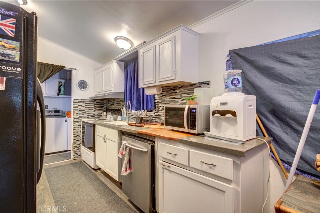 700 River Road, Unit 12 San Miguel, CA 93451 - Photo 8 of 13 a kitchen with cabinets and stainless steel appliances