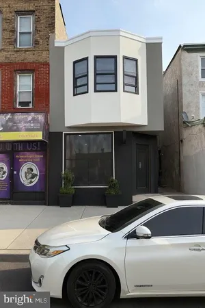 a black car parked in front of a building