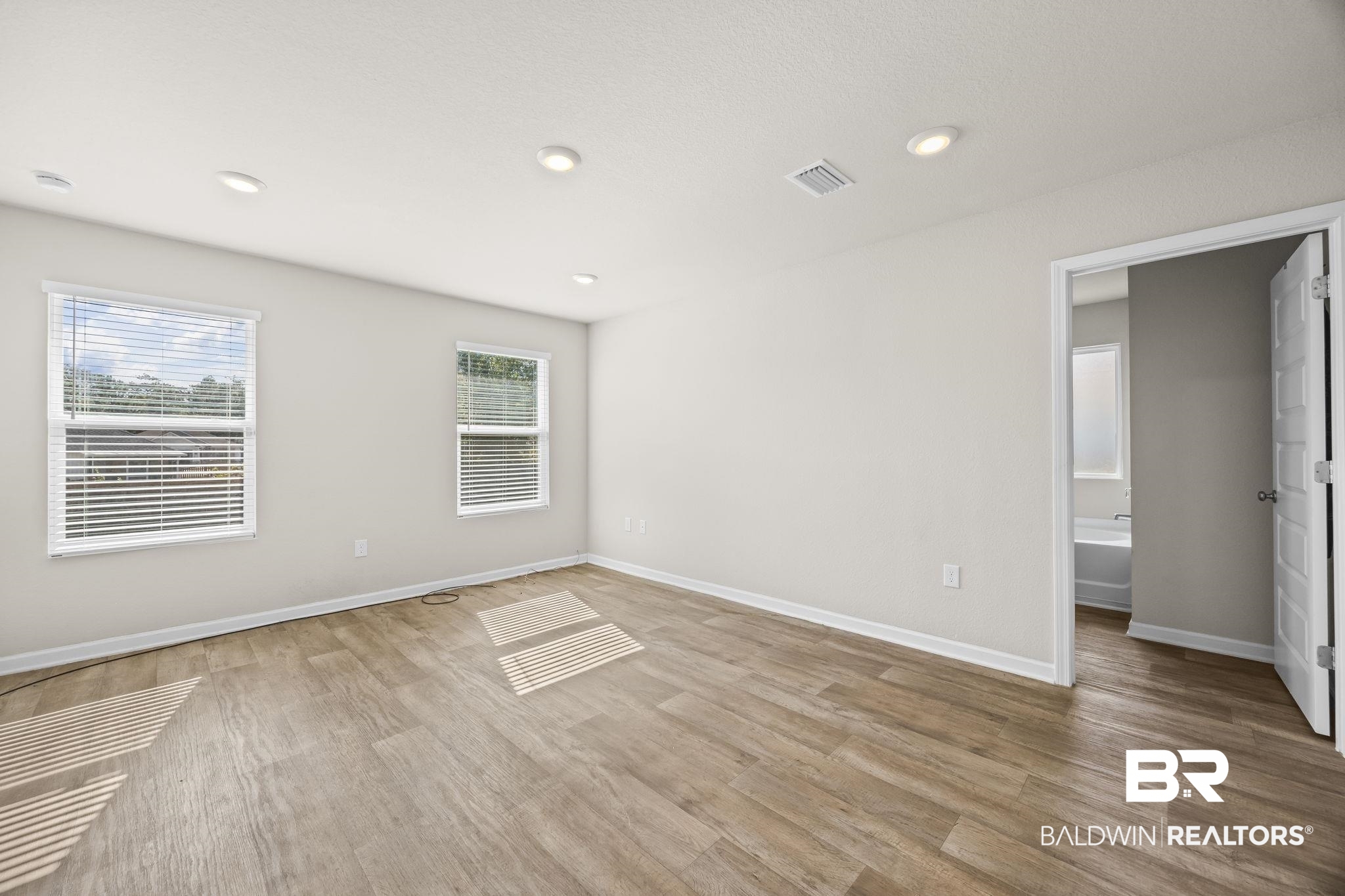 3090 Camino Real Loop Lillian, AL 36549 - Photo 24 of 29 Empty room with light wood-type flooring and recessed lighting