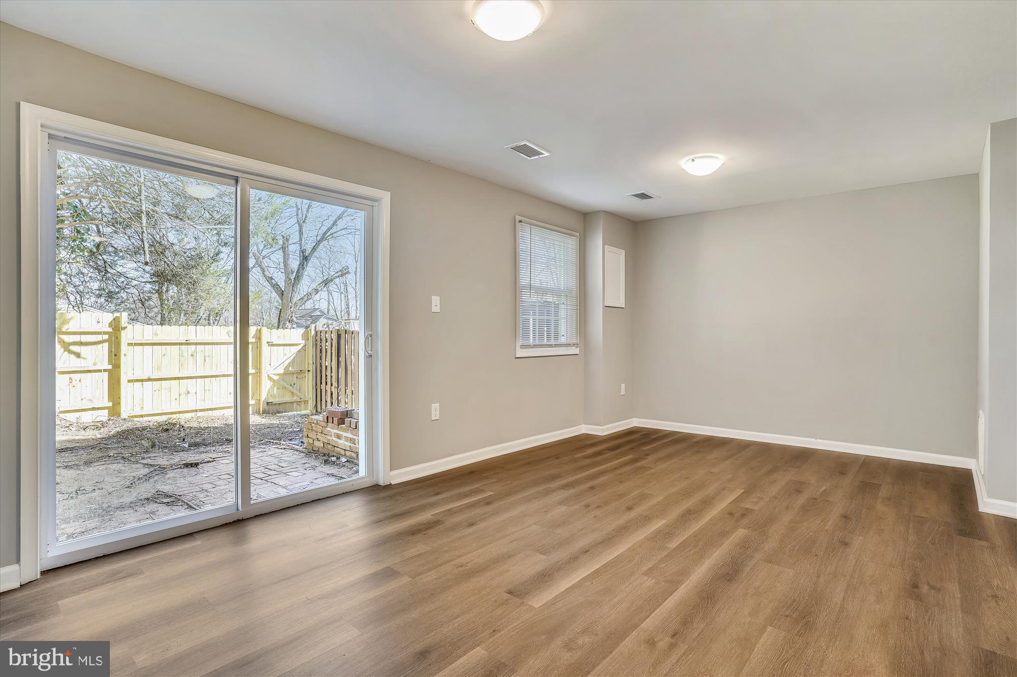 9202 Sprucewood Road Burke, VA 22015 - Photo 19 of 21 an empty room with wooden floor and windows