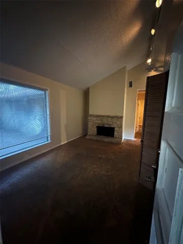 a view of empty room with a fireplace