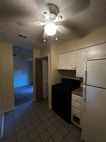 a kitchen with a refrigerator and a refrigerator