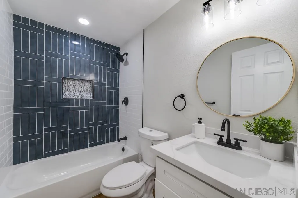 5845 Friars Road, Unit 1116 San Diego, CA 92110 - Photo 11 of 30 a bathroom with a sink a toilet and shower