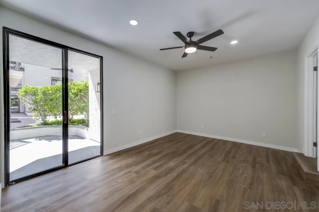 5845 Friars Road, Unit 1116 San Diego, CA 92110 - Photo 15 of 30 an empty room with wooden floor and windows