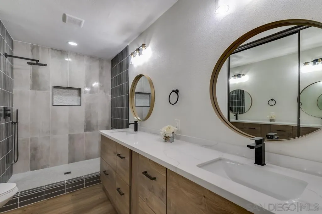 5845 Friars Road, Unit 1116 San Diego, CA 92110 - Photo 17 of 30 a bathroom with a sink double vanity and a mirror