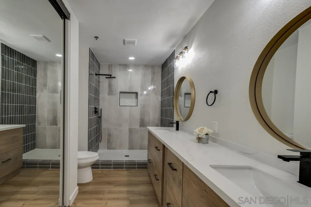 5845 Friars Road, Unit 1116 San Diego, CA 92110 - Photo 18 of 30 a bathroom with a sink a toilet and shower