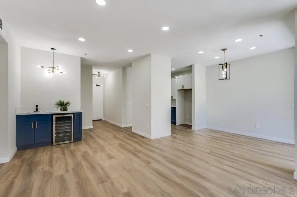 5845 Friars Road, Unit 1116 San Diego, CA 92110 - Photo 3 of 30 a view of a big room with wooden floor and windows
