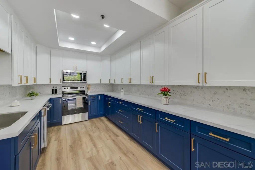 5845 Friars Road, Unit 1116 San Diego, CA 92110 - Photo 6 of 30 a kitchen with stainless steel appliances granite countertop a sink dishwasher stove and refrigerator