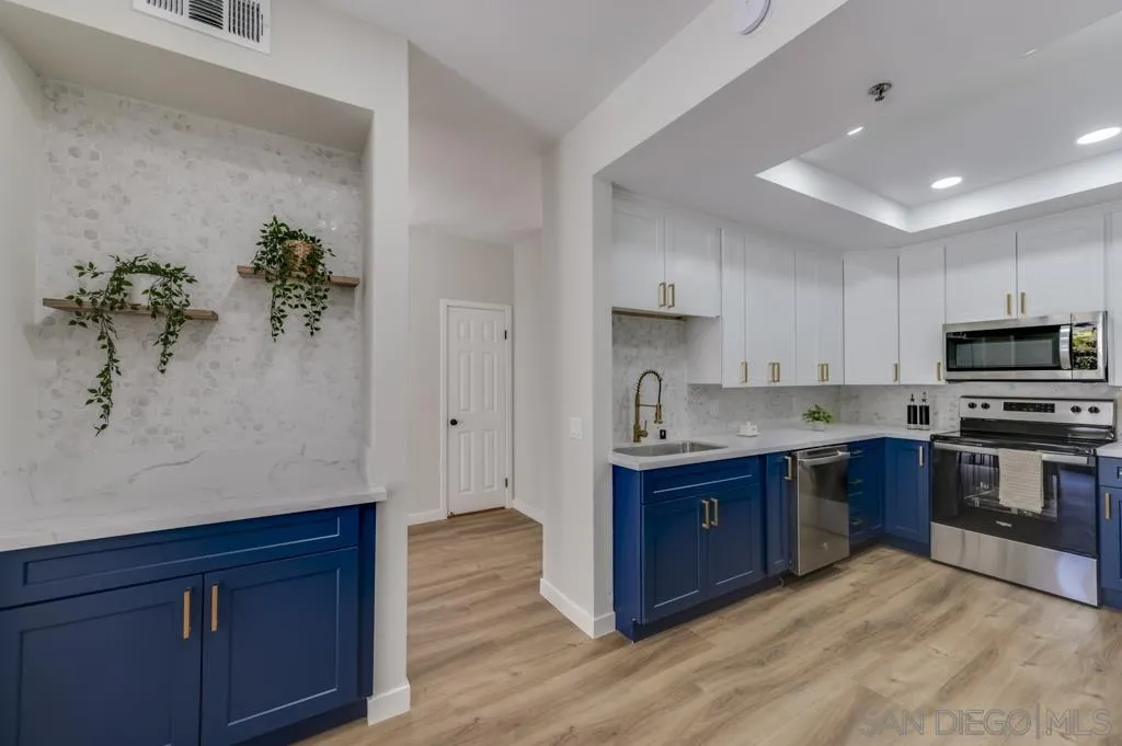 5845 Friars Road, Unit 1116 San Diego, CA 92110 - Photo 8 of 30 a kitchen with stainless steel appliances granite countertop a stove a sink and a refrigerator