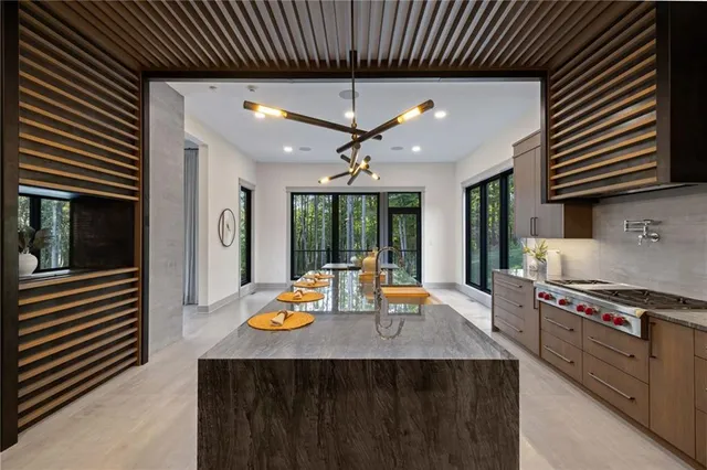 a kitchen with stainless steel appliances granite countertop a sink stove and cabinets