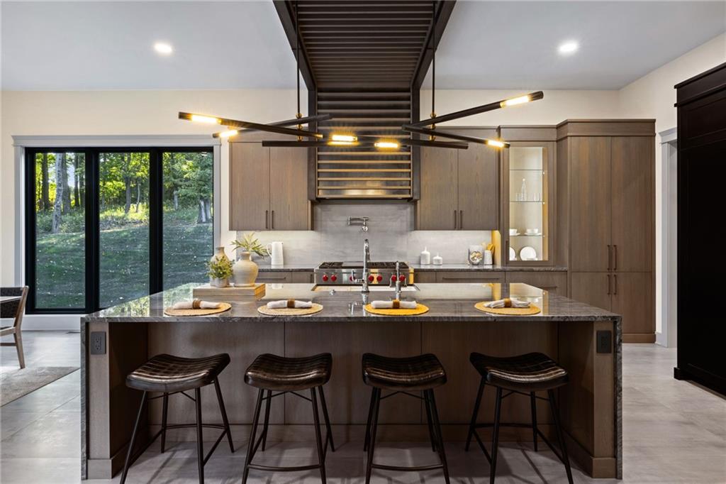 809 Mt Pleasant Road Mars, PA 16046 - Photo 12 of 46 a dining room with stainless steel appliances kitchen island granite countertop furniture a large window and a refrigerator
