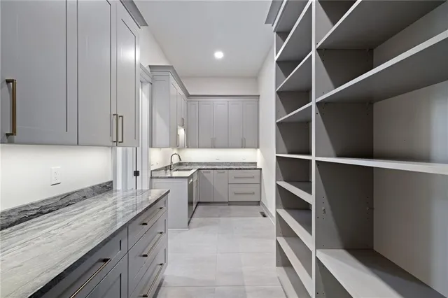 a kitchen with a refrigerator and white cabinets