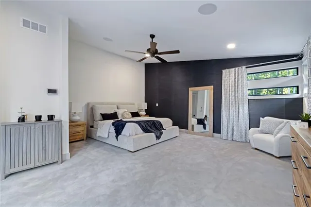 a spacious bedroom with a bed and a couch