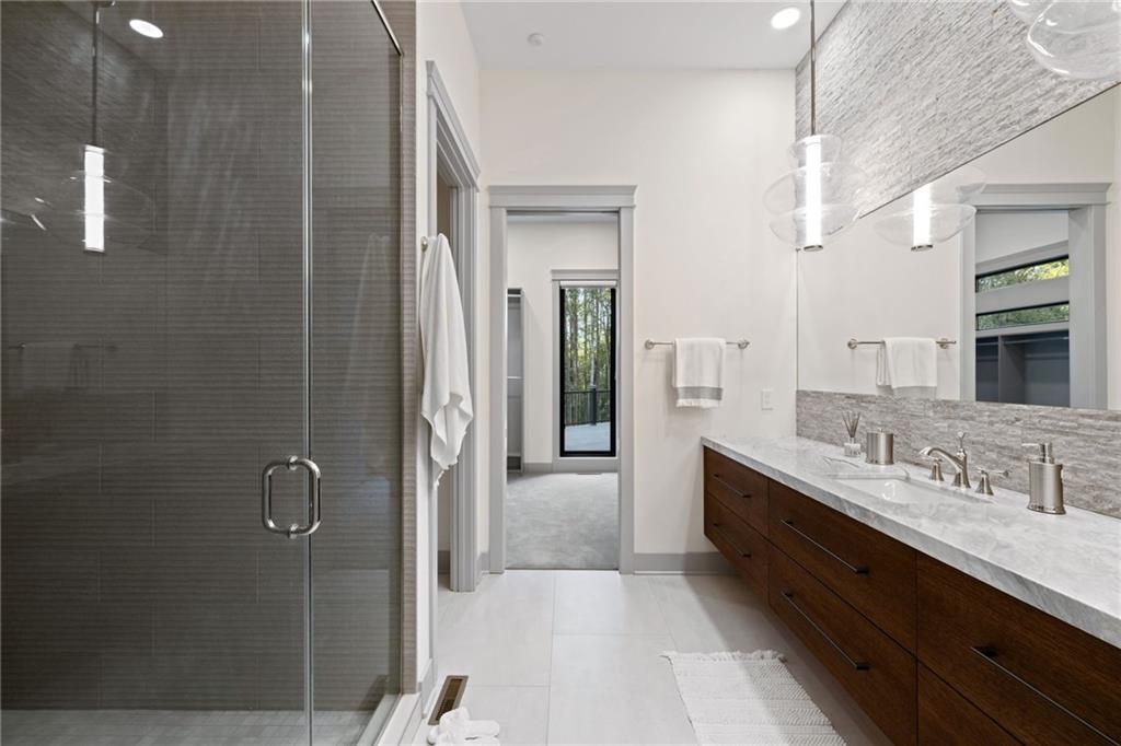 809 Mt Pleasant Road Mars, PA 16046 - Photo 20 of 46 a en suite bathroom with a double vanity sink a large mirror and shower