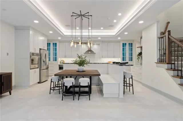 a large kitchen with a table and chairs