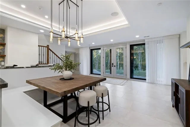 a view of a dining room with furniture and a chandelier