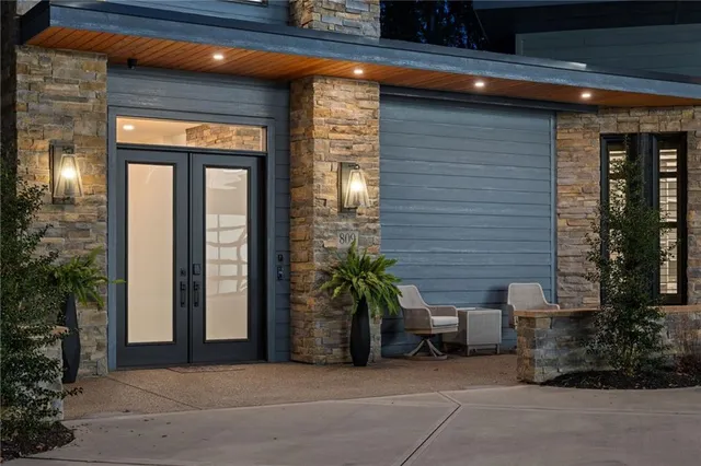 a view of a brick house with potted plants