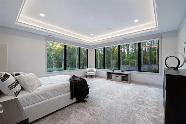 a bedroom with furniture and a large window