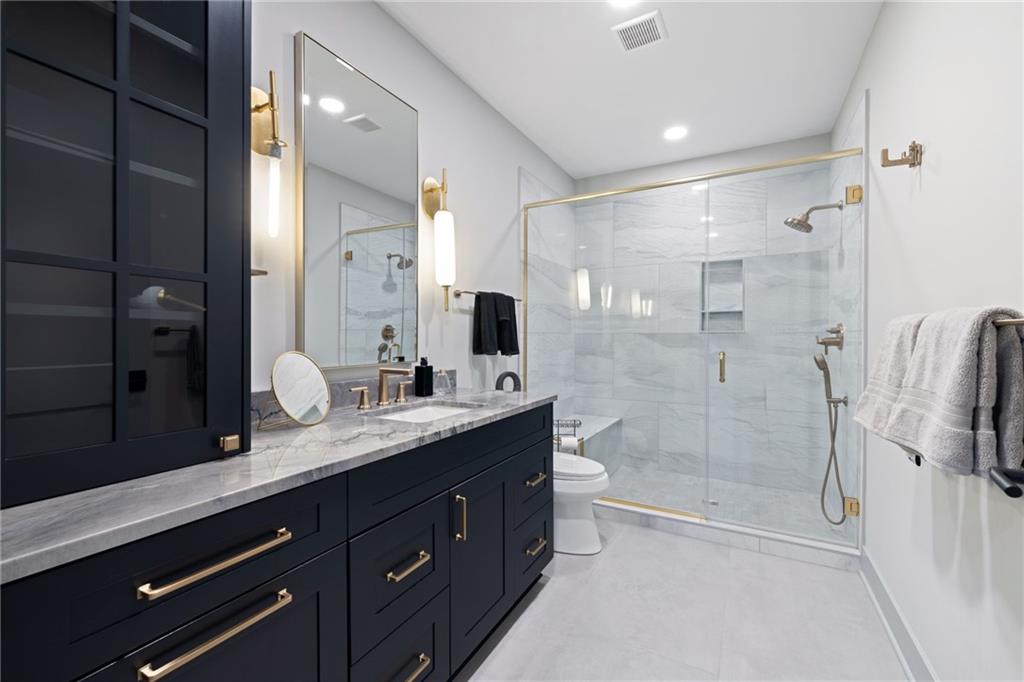 809 Mt Pleasant Road Mars, PA 16046 - Photo 32 of 46 a bathroom with a granite countertop sink mirror and shower
