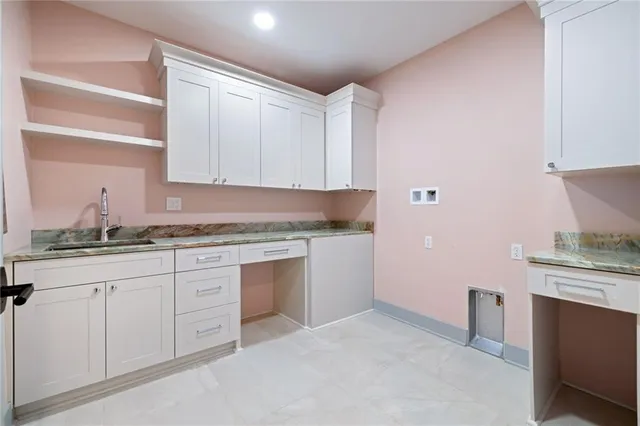 a kitchen with granite countertop white cabinets and white appliances