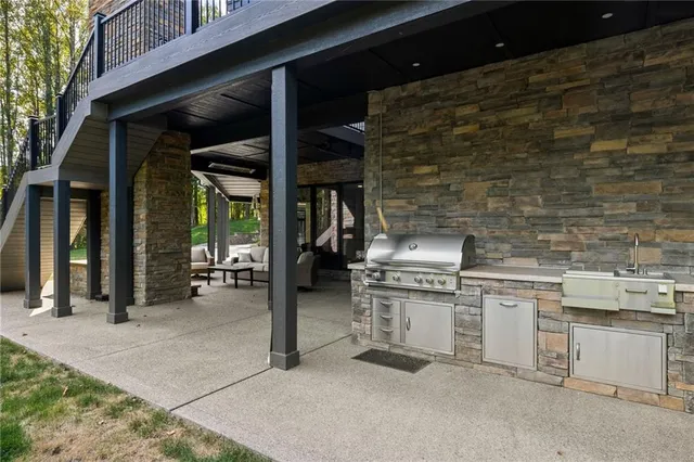 a kitchen with stainless steel appliances granite countertop a stove and a sink