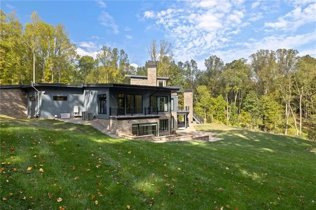 a view of a house with backyard and sitting area