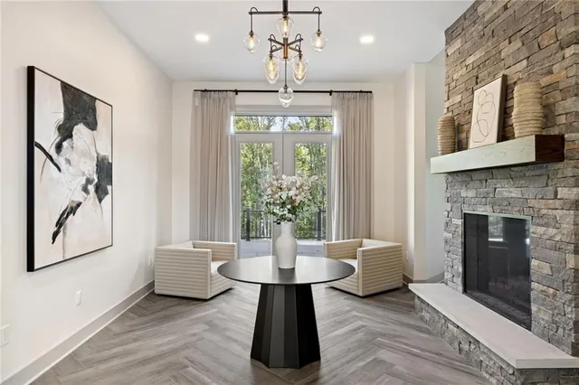 a living room with furniture and a chandelier