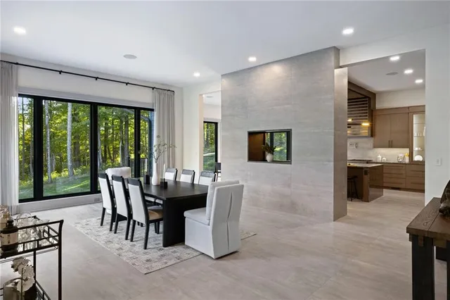 a dining room with furniture and large windows