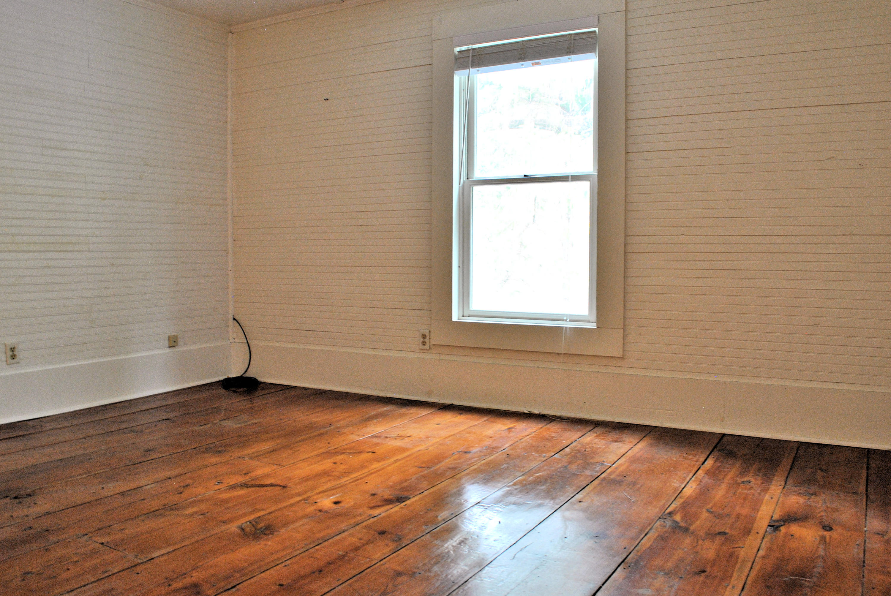 6500 Little Camp Road Riner, VA 24149 - Photo 59 of 121 an empty room with wooden floor and windows