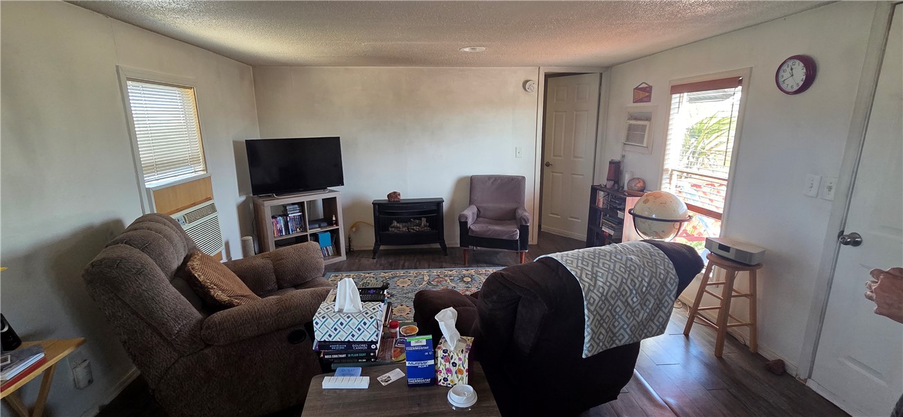 5397 Cordes Road Golden Valley, AZ 86413 - Photo 4 of 50 a living room with furniture a flat screen tv and wooden floor