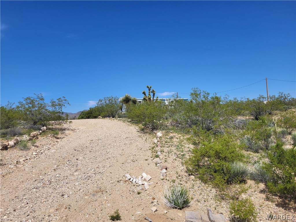 5397 Cordes Road Golden Valley, AZ 86413 - Photo 45 of 50 a view of a beach with a house in the background