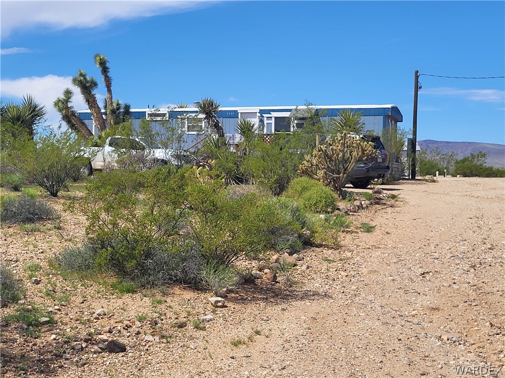 5397 Cordes Road Golden Valley, AZ 86413 - Photo 49 of 50 a view of a dry yard with trees