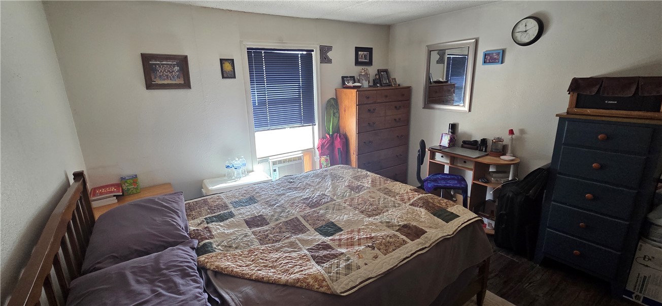 5397 Cordes Road Golden Valley, AZ 86413 - Photo 10 of 50 a bed sitting in a bedroom next to a window with bookshelf