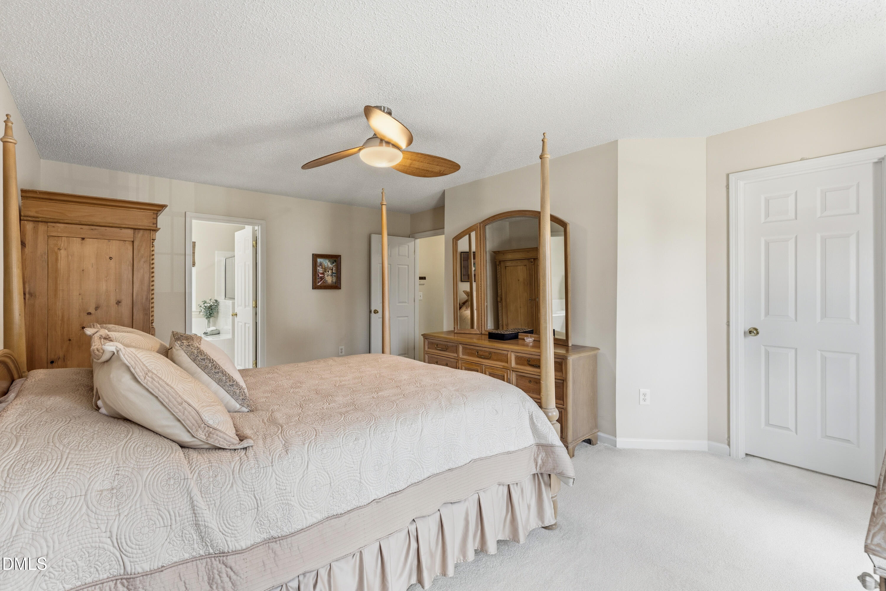 1211 Waterford Green Drive Apex, NC 27502 - Photo 32 of 53 a bedroom with a bed and a chandelier