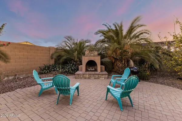 a view of a chair and table in back yard of the house