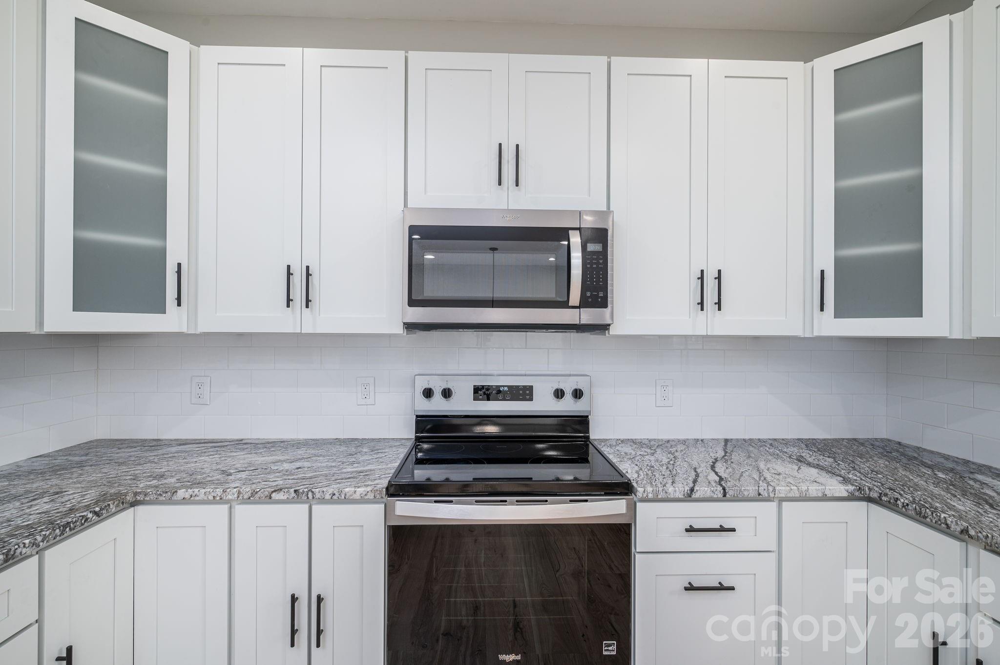 2474 Shoal Road Crouse, NC 28033 - Photo 17 of 39 a kitchen with stainless steel appliances granite countertop white cabinets and a stove a sink