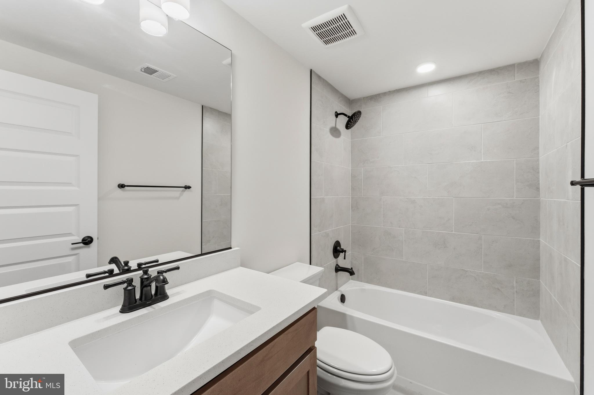 19110 Tatie Way Poolesville, MD 20837 - Photo 24 of 29 a bathroom with a bathtub shower sink vanity mirror and toilet