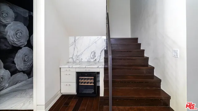 a living room with couch and a clock
