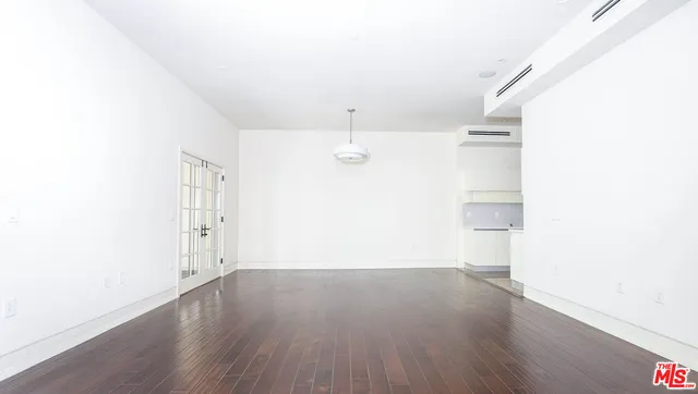 a view of a room with wooden floor