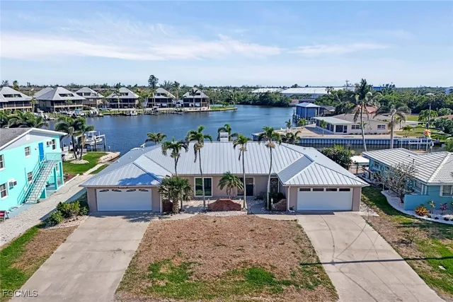 an aerial view of a house with a ocean view