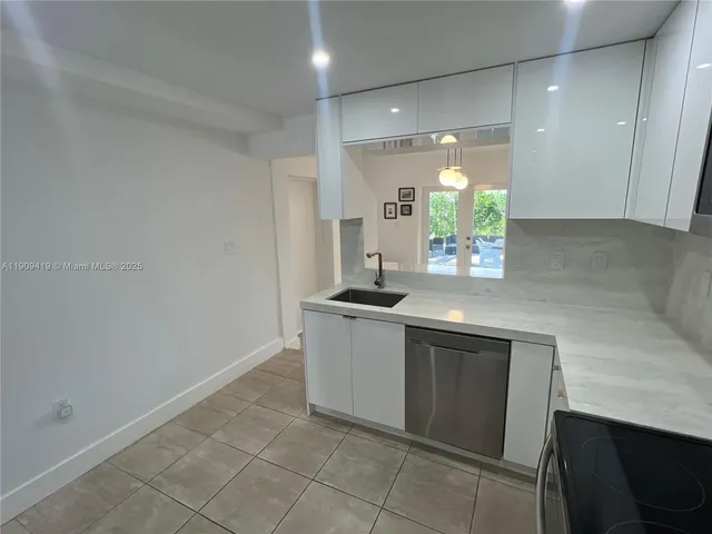 a kitchen with a sink cabinets and window