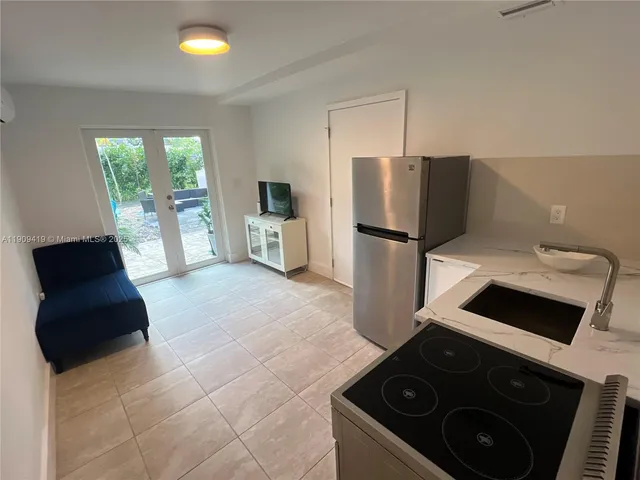 a kitchen with a stove a refrigerator and a sink