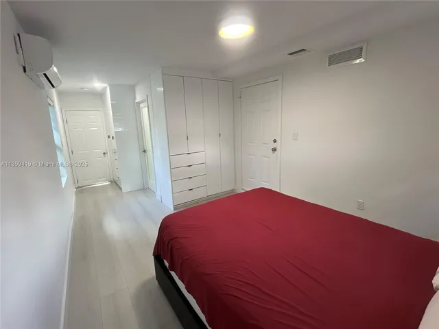 a bedroom with a bed and a bathroom