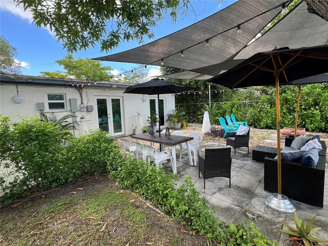 a patio with table and chairs