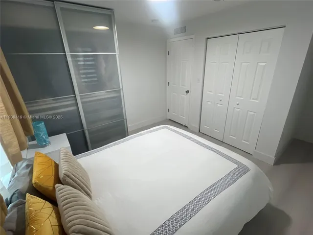 a bedroom with a bed and a shower
