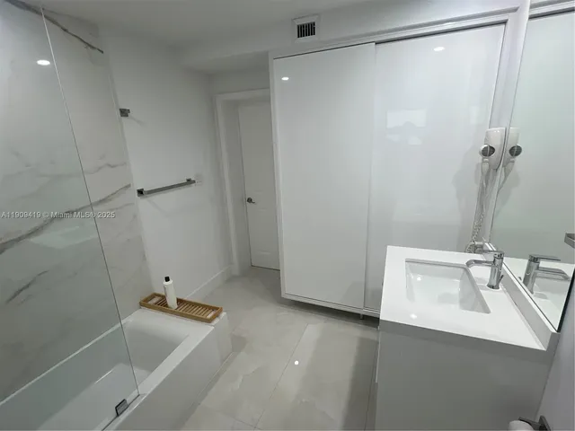 a bathroom with a sink and shower