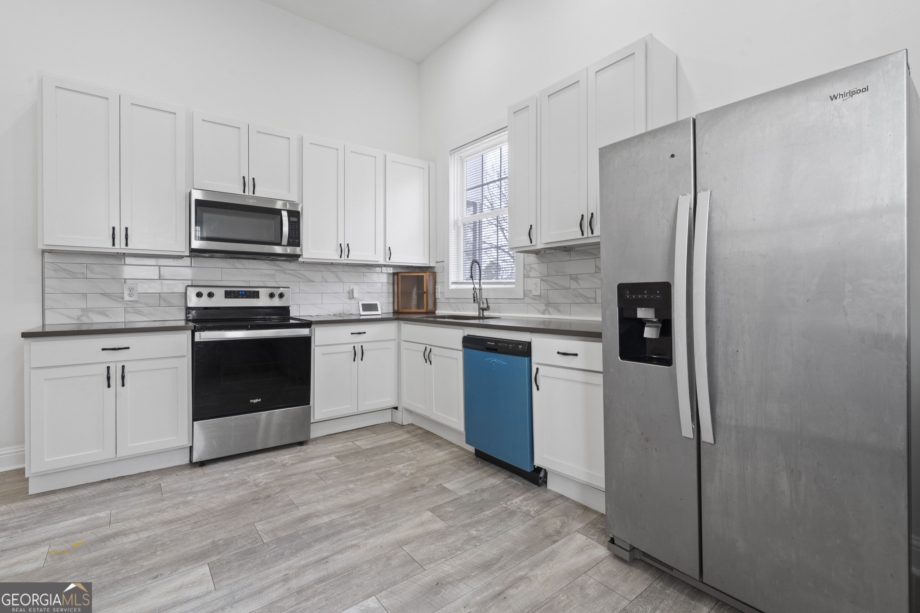 1471 Jackson Street Macon, GA 31201 - Photo 12 of 30 a kitchen with a refrigerator sink and stove top oven