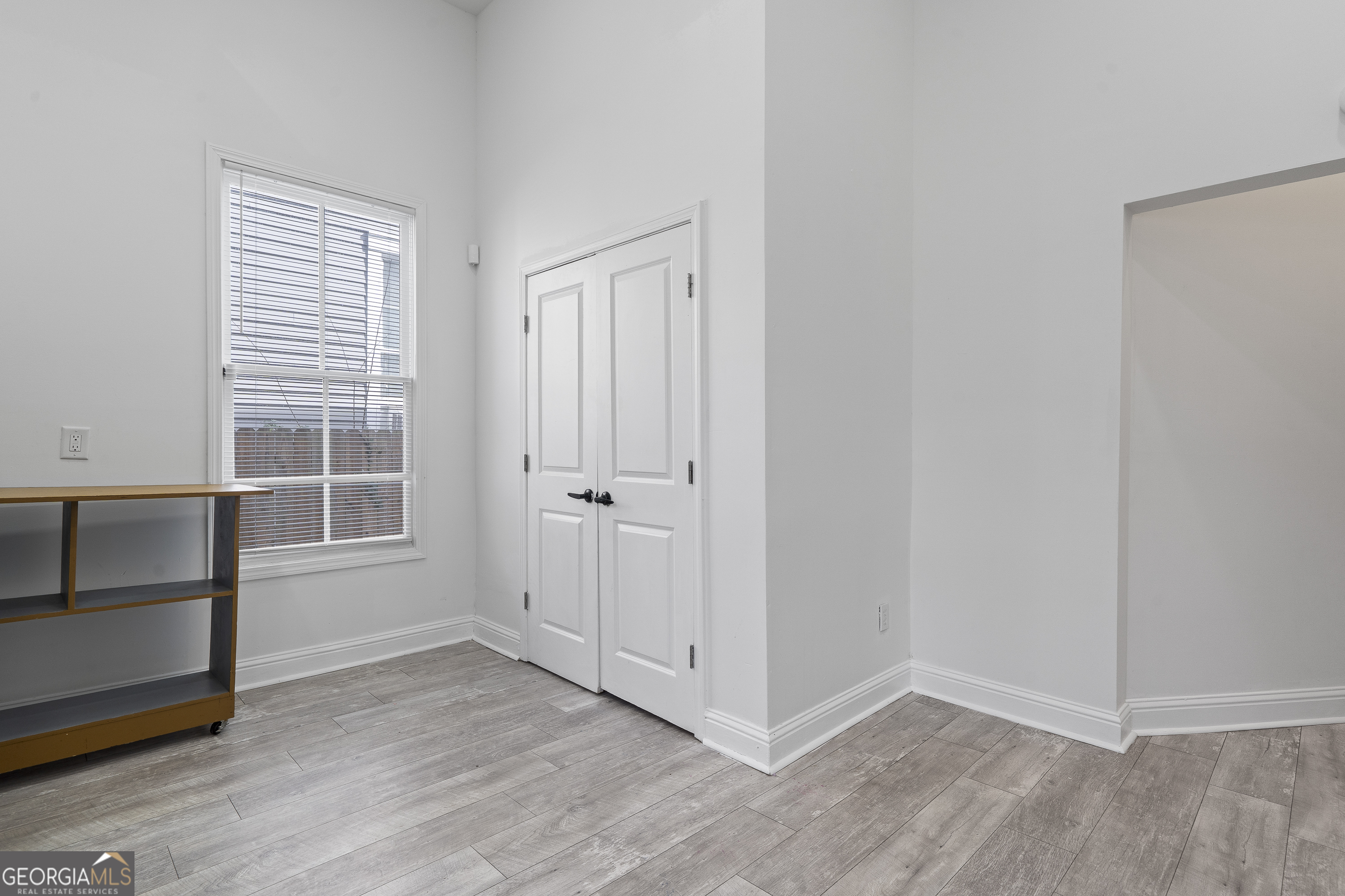 1471 Jackson Street Macon, GA 31201 - Photo 13 of 30 a view of empty room with wooden floor and window
