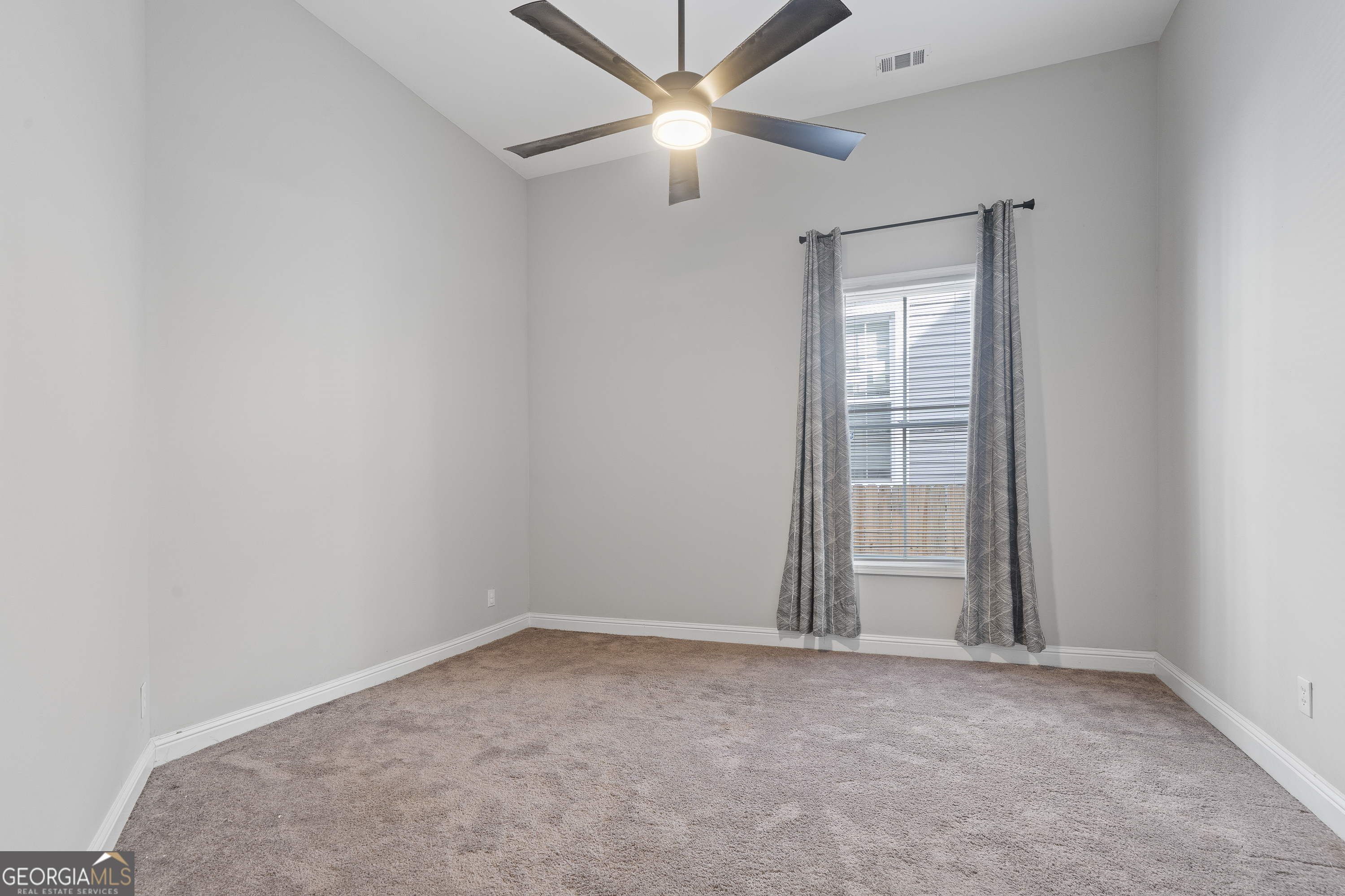 1471 Jackson Street Macon, GA 31201 - Photo 21 of 30 an empty room with closet and a ceiling fan